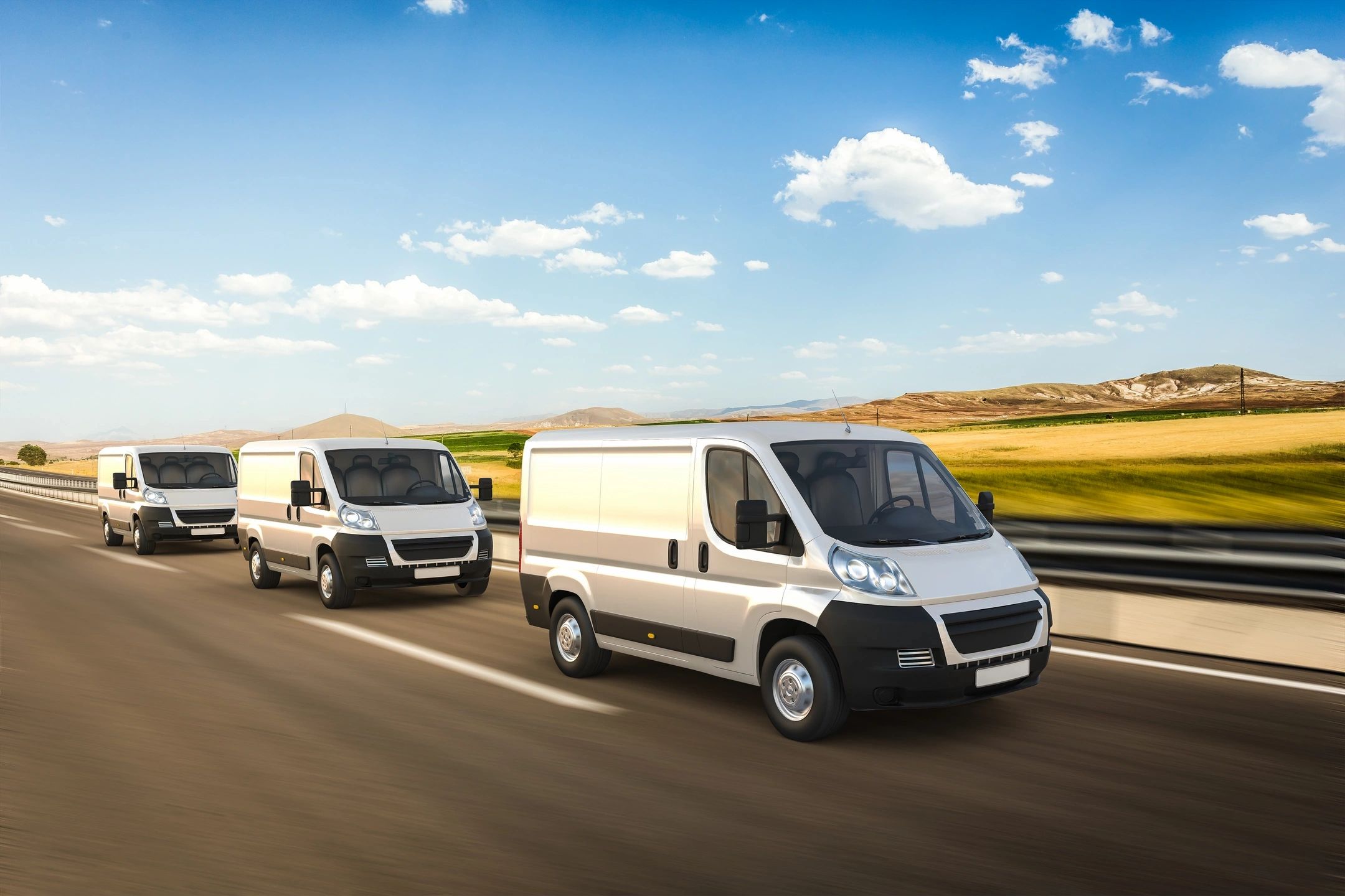 Fleet of vans on highway